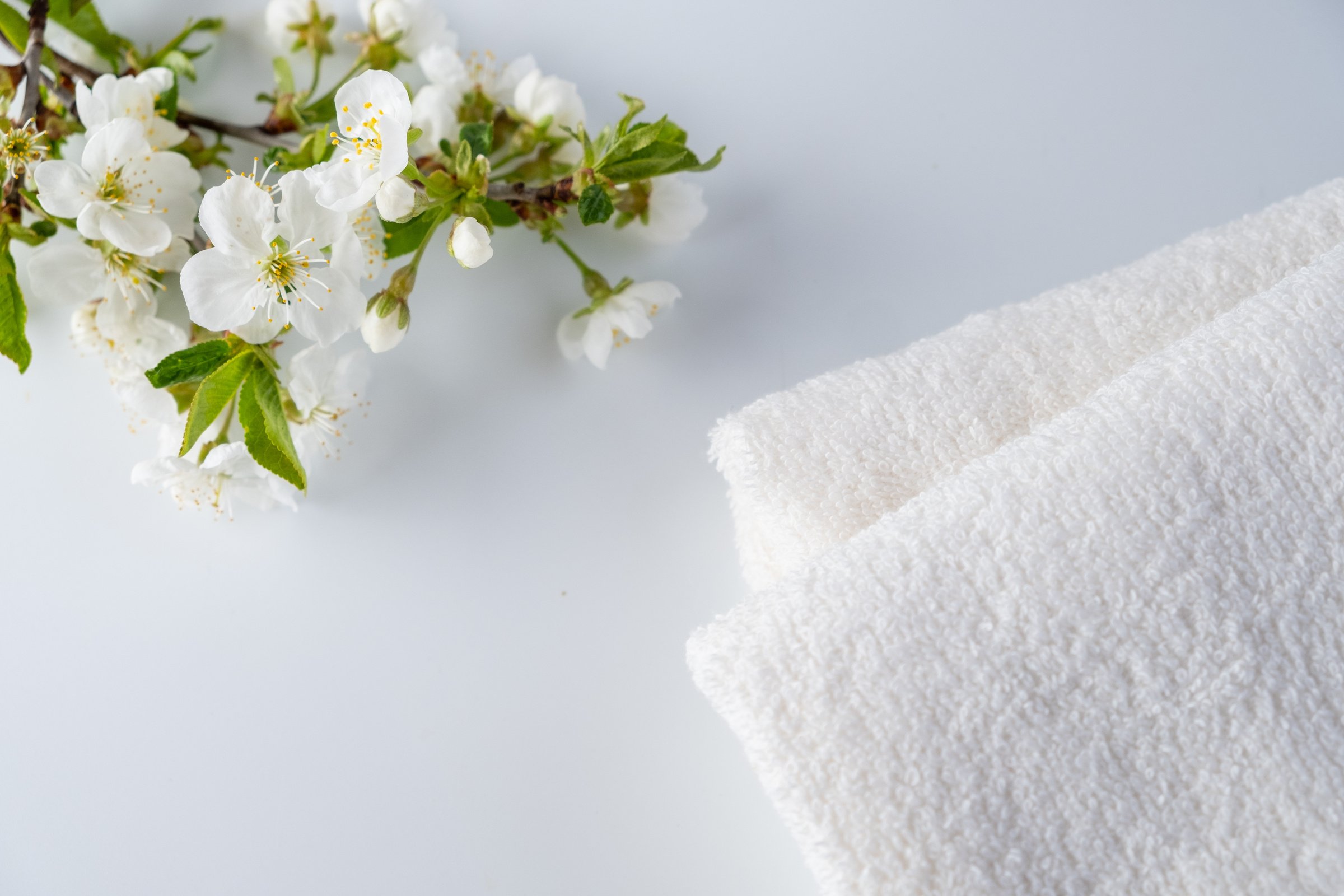 Flowers and White Towels on White Surface